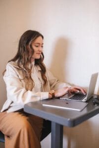 a wedding industry virtual assistant typing on a laptop sat at a table
