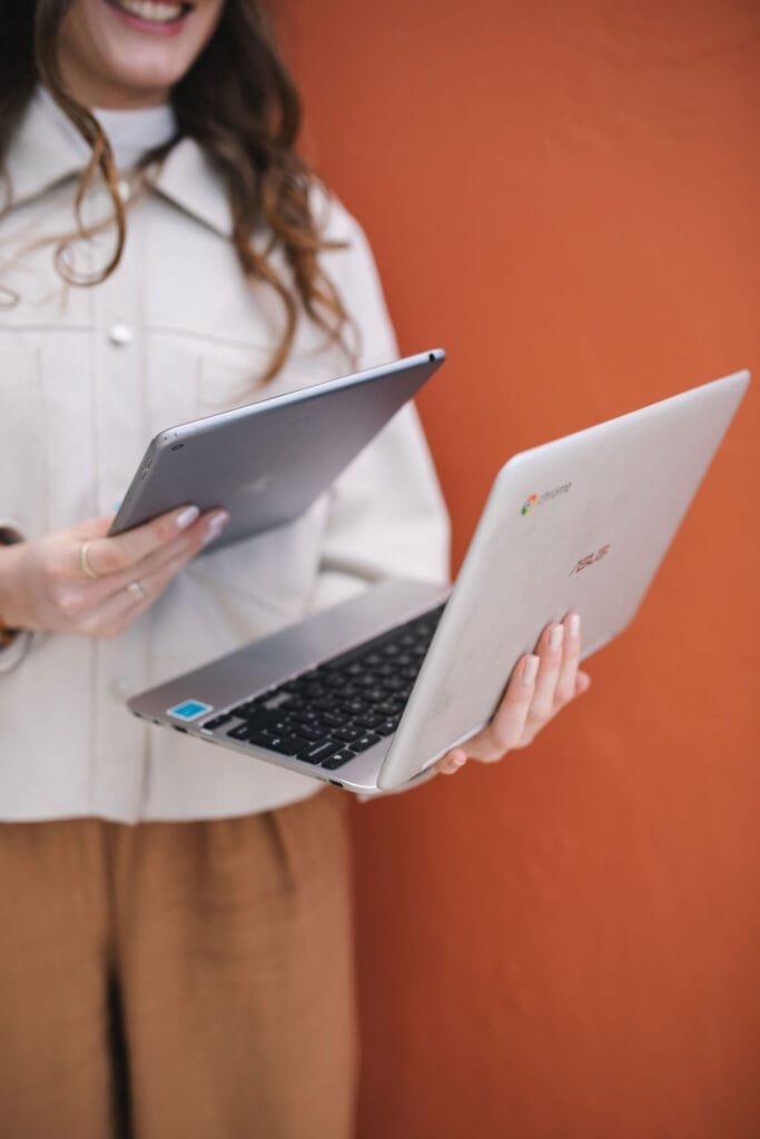 wedding industry virtual assistant holding a laptop and an ipad