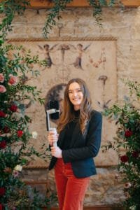 A Wedding Supplier Content Creator next to a flower arrangement