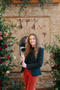 A Wedding Supplier Content Creator next to a flower arrangement