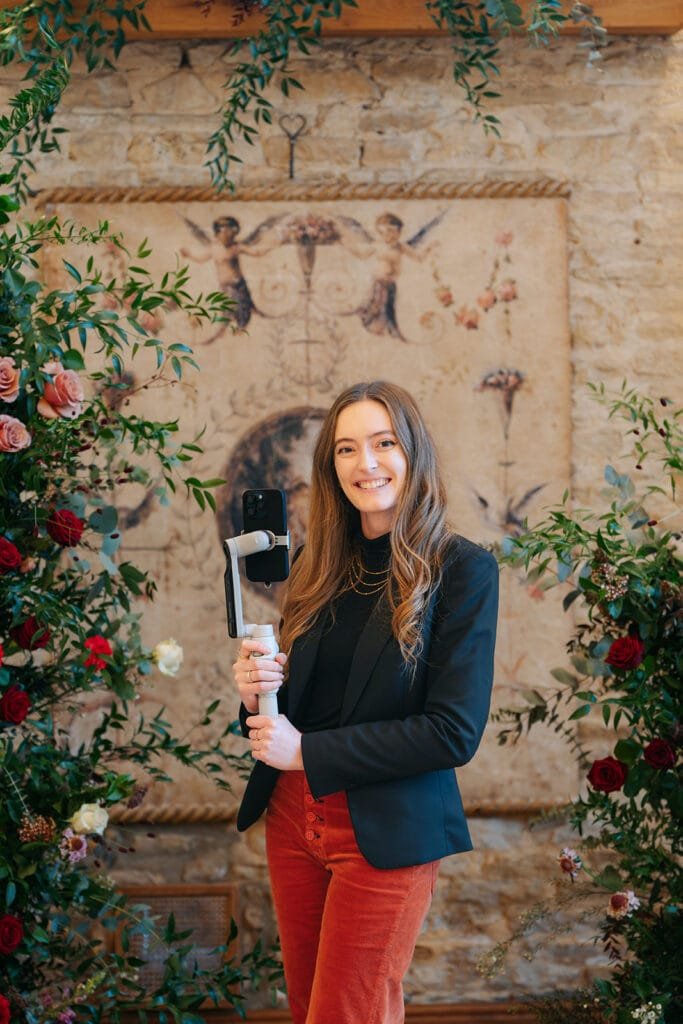 A Wedding Supplier Content Creator next to a flower arrangement